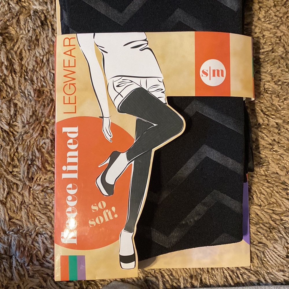 Black leggings, thin fleece lining, with design from waist to ankles, never worn